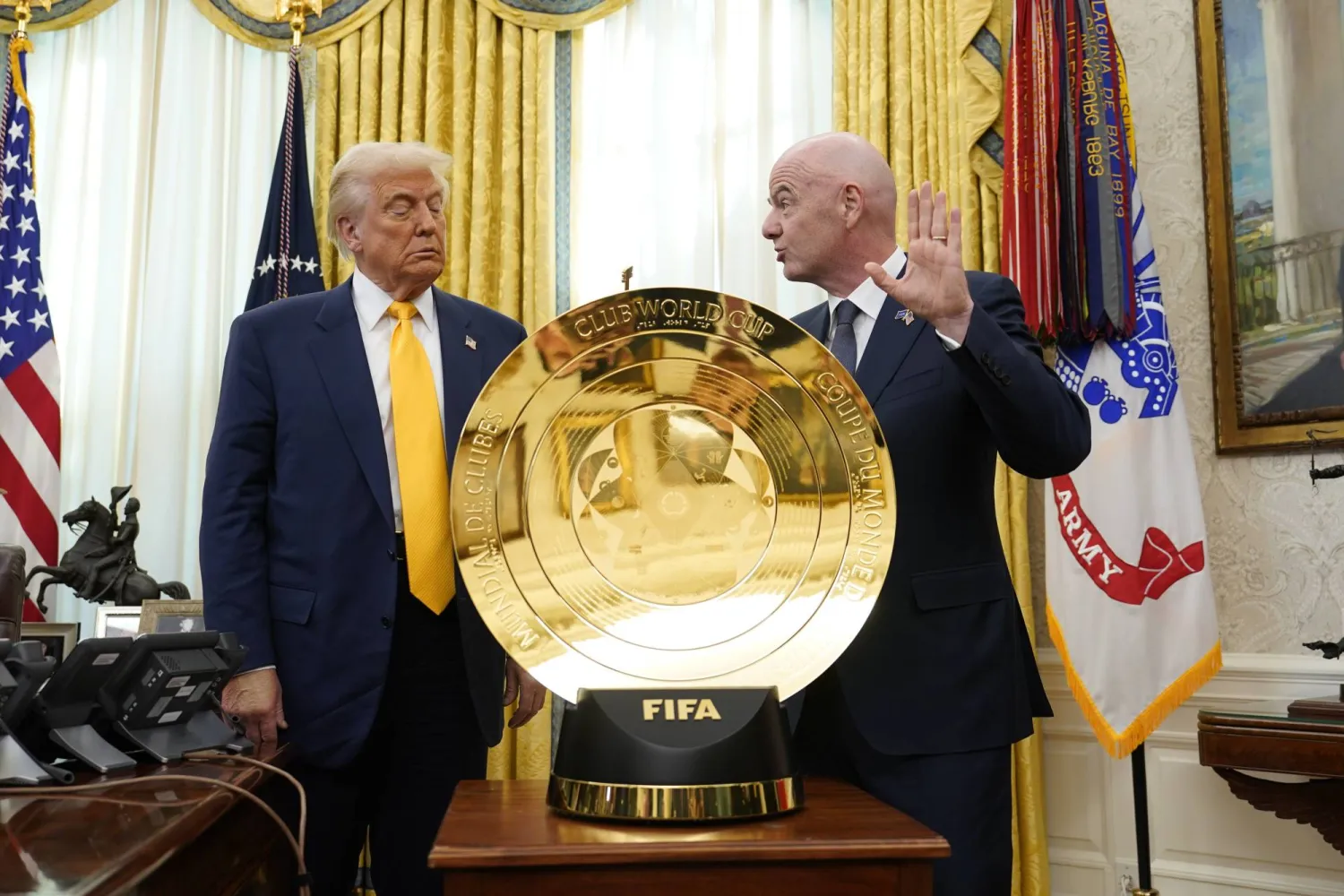 United States President Donald J Trump (L) stands with FIFA President Gianni Infantino and the Club World Cup trophy after signing an Executive Order setting up a task force on the Club World Cup in the Oval Office of the White House in Washington, DC, USA, 07 March 2025. EPA/CHRIS KLEPONIS / POOL