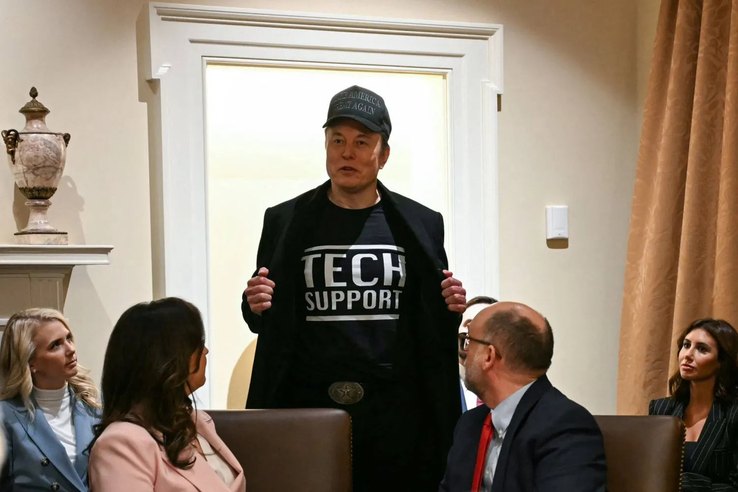 (FILES) Leader of the Department of Government Efficiency Elon Musk wears a shirt that says "Tech Support" as he speaks during a cabinet meeting with US President Donald Trump at the White House in Washington, DC, on February 26, 2025. (Photo by Jim WATSON / AFP)