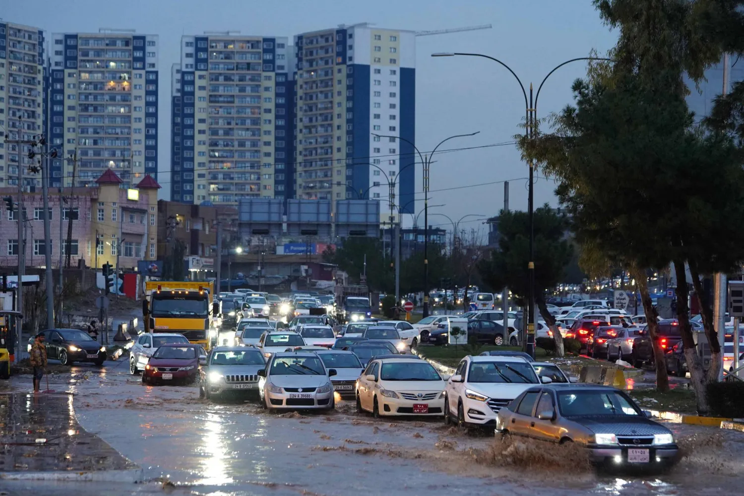 Vehicles drive in a flooded street following heavy rains in Duhok, in Iraq's northern autonomous Kurdistan region, on March 10, 2025. (Photo by Ismael ADNAN / AFP)