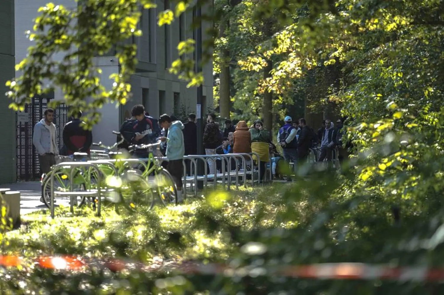 Dozens of people from all over the world line in front of the central registration center for asylum-seekers in Berlin, Germany, Monday, Sept. 25, 2023. (AP) 