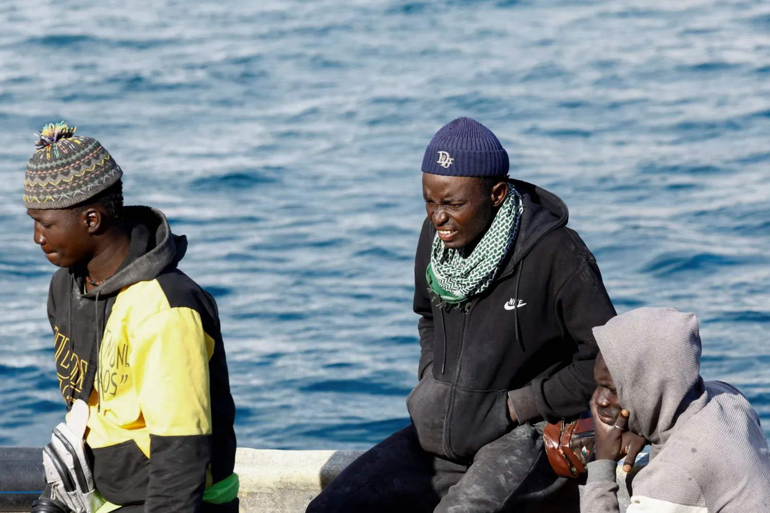 Migrants wait to disembark from a fiber boat in the port of Arguineguin, on the island of Gran Canaria, Spain, March 5, 2025. REUTERS/Borja Suarez