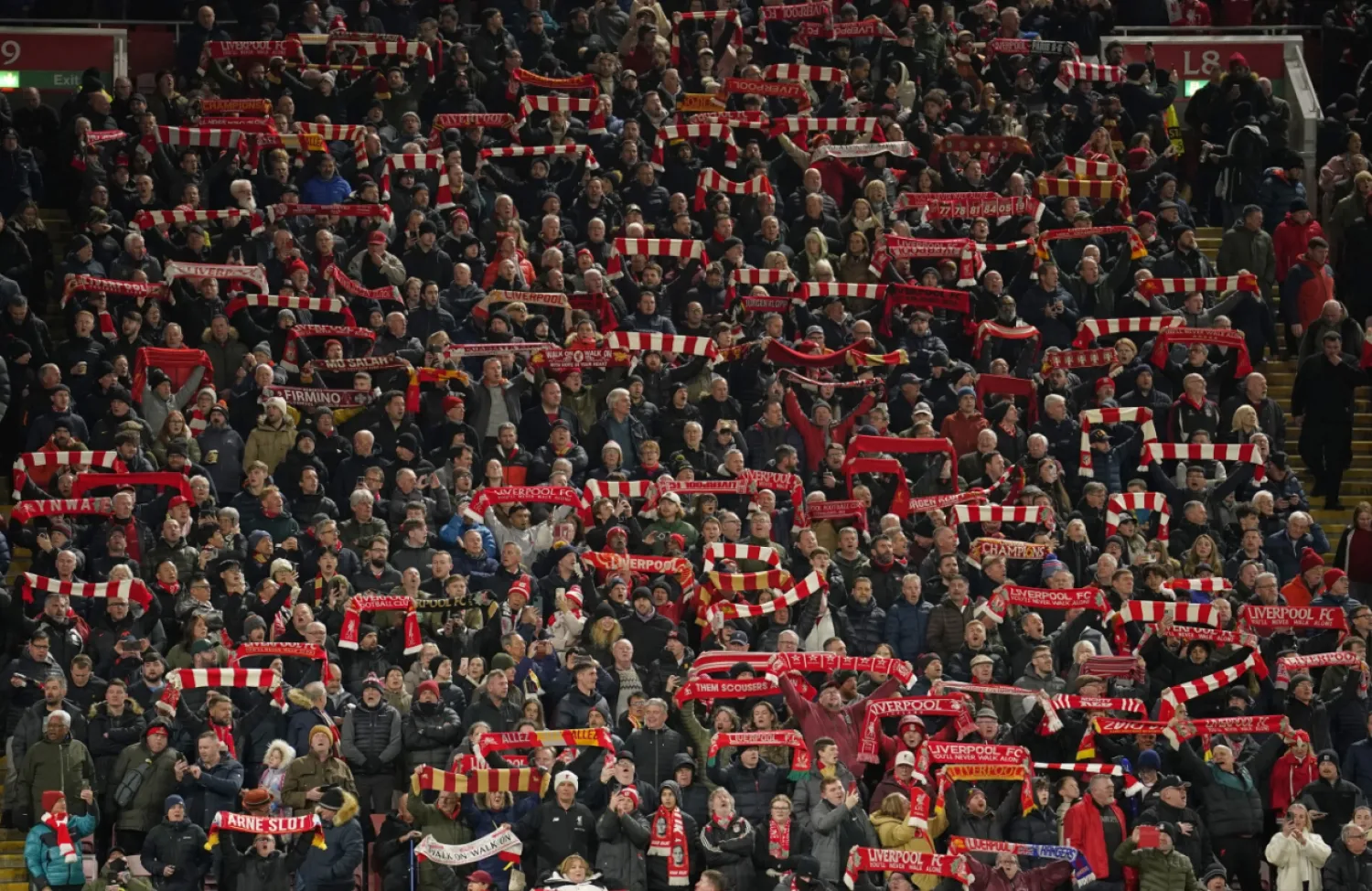 Liverpool supporters wait for the start of the Champions League round of 16 second leg soccer match between Liverpool and Paris Saint-Germain at Anfield in Liverpool, England, Tuesday, March 11, 2025. (AP Photo/Dave Thompson)