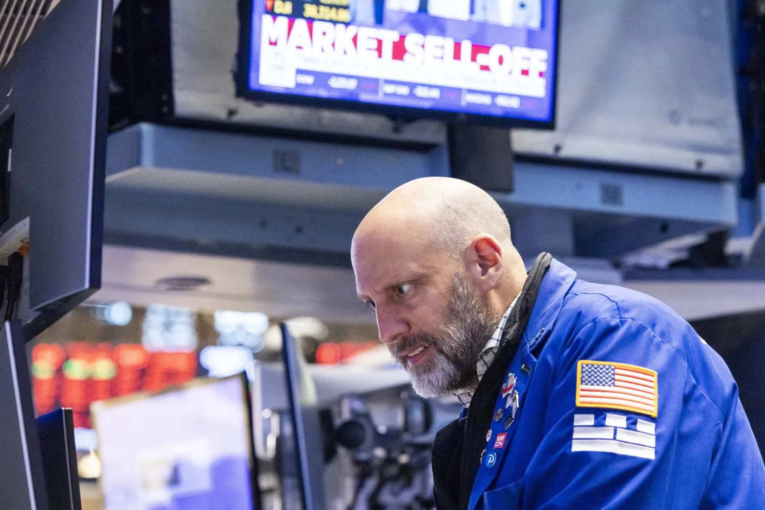 متداول في بورصة نيويورك يرصد تراجعات الأسهم بعد قرار ترمب فرض رسوم جمركية جديدة (إ.ب.أ)