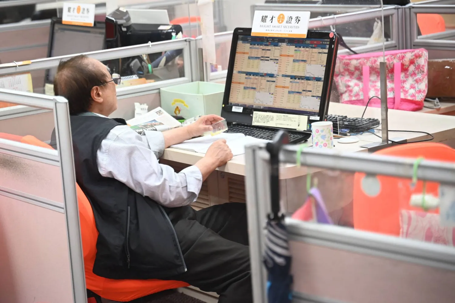 متداول يعمل بشركة وساطة للأوراق المالية في هونغ كونغ (أ.ف.ب)