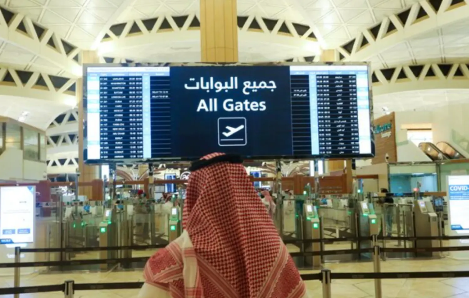 A Saudi man checks the flight timings at the King Khalid International Airport in Riyadh, Saudi Arabia, May 16, 2021. REUTERS/Ahmed Yosri