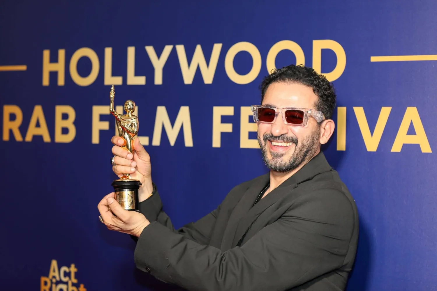 حلمي محتفياً بالجائزة على السجادة الحمراء (إدارة المهرجان)
