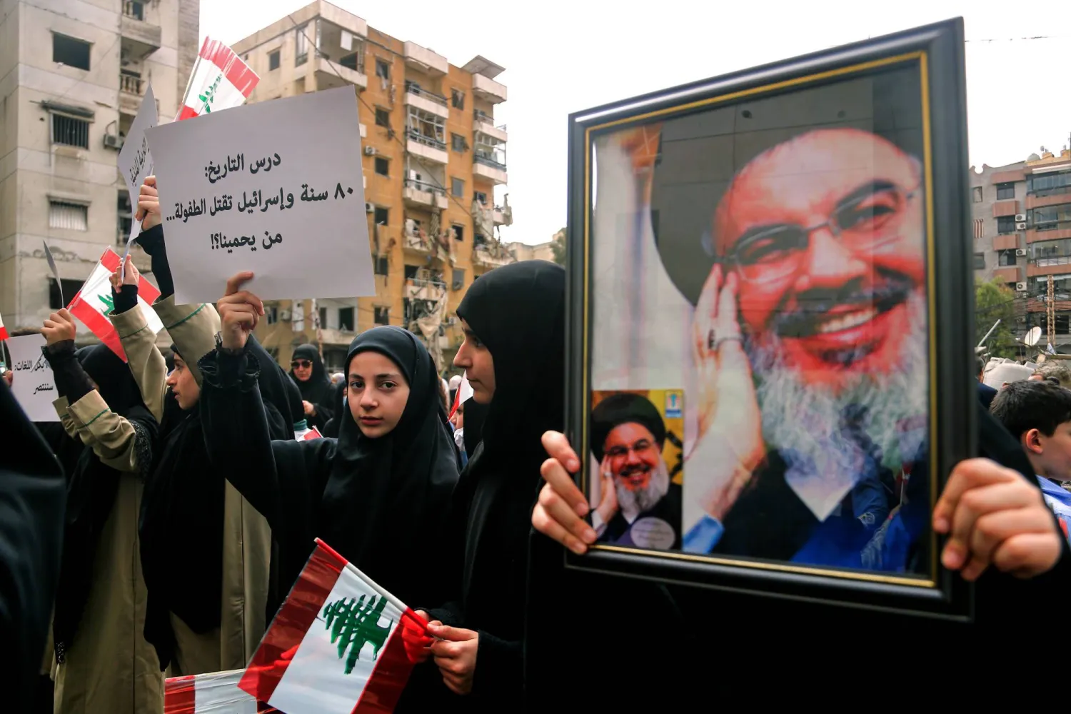 مناصرون لـ«حزب الله» يرفعون صورة أمينه العام السابق حسن نصر الله قرب موقع استهداف إسرائيلي بالضاحية الجنوبية لبيروت الشهر الماضي (د.ب.أ)