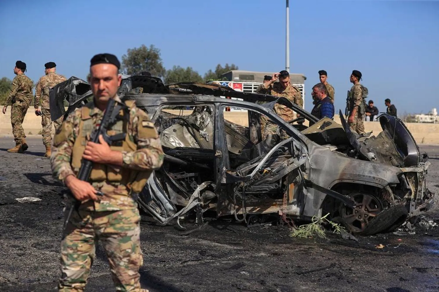  Lebanese army members gather near a charred car that was hit by an Israeli strike, in the southern coastal town of Ghazieh, Lebanon, Friday, April 18, 2025. (AP)