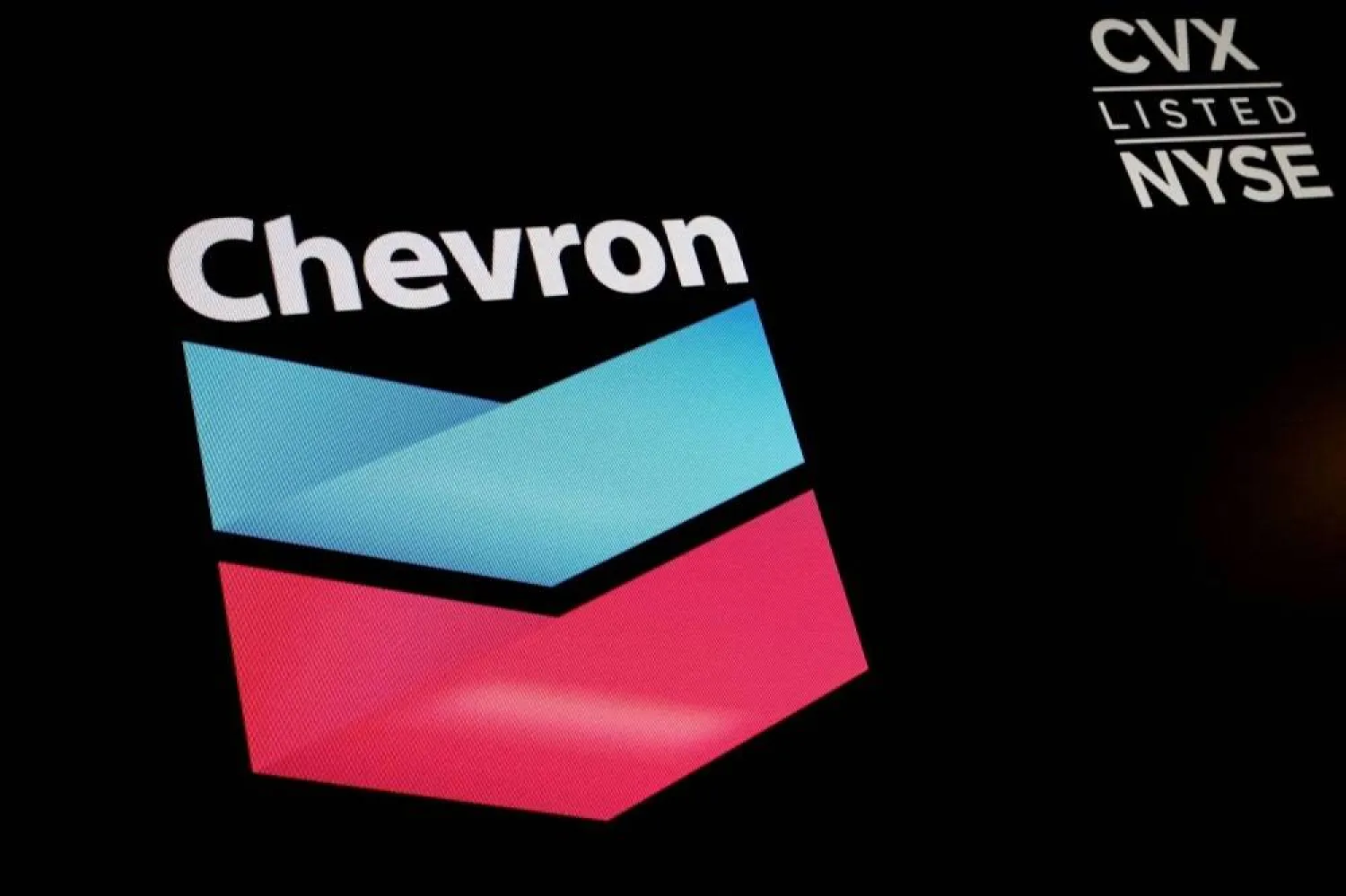 The logo and trading information for Chevron is displayed on a screen on the floor of the New York Stock Exchange (NYSE) in New York City, US, June 27, 2022. (Reuters) 