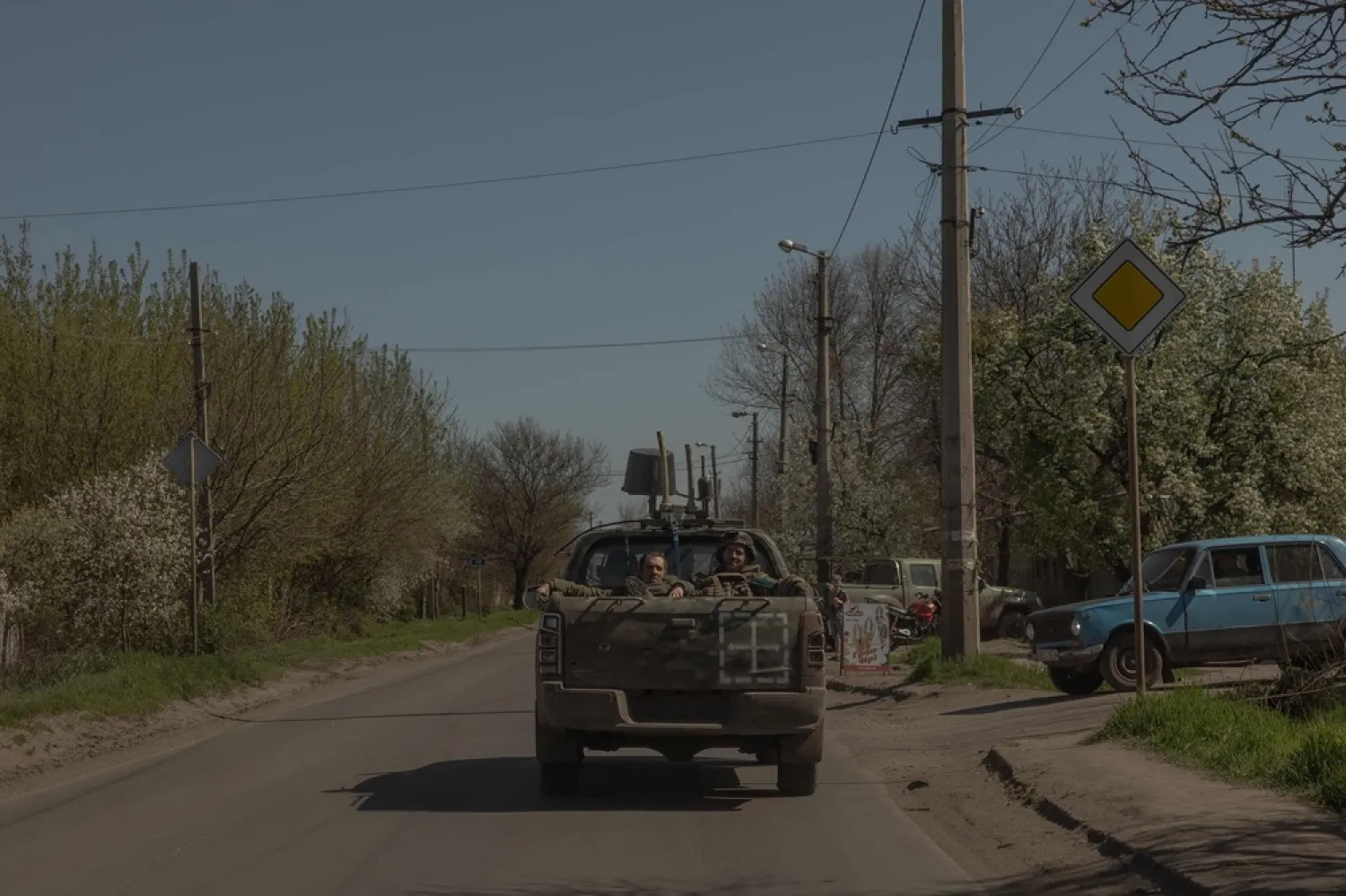 Ukrainian soldiers sit at the back of a pickup truck, in the Donetsk region, on April 20, 2025, amid the Russian invasion of Ukraine. (AFP) 