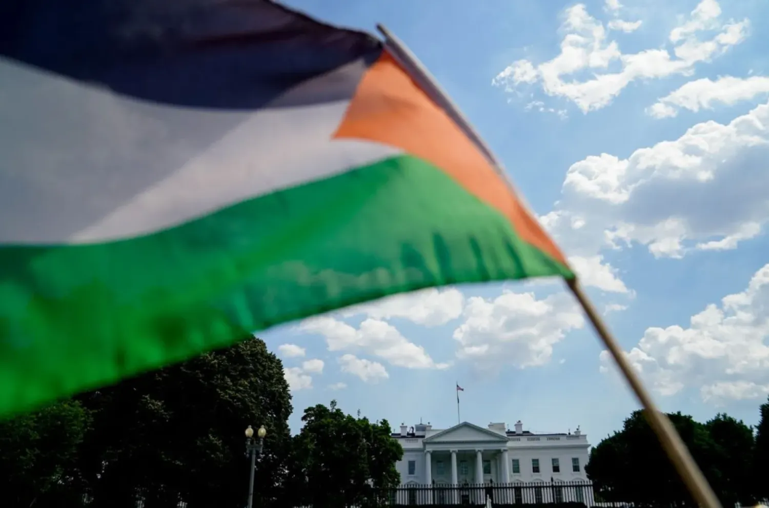 Activists wave a Palestinian flag outside the White House during a memorial for Palestinians who have died during the past year of Israeli-Palestinian violence, in Washington, US, June 5, 2021. REUTERS/Erin Scott/File Photo
