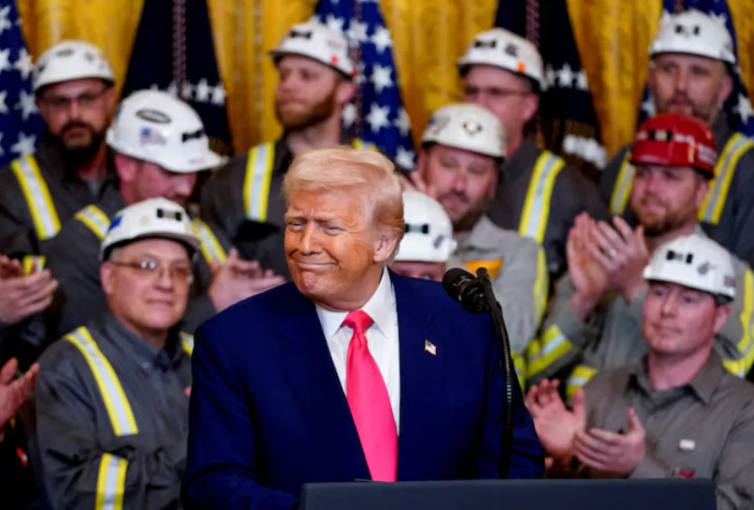 US President Donald Trump reacts next to coal industry workers, on the day he signs energy-related executive orders at the White House in Washington, D.C., US, April 8, 2025. REUTERS/Nathan Howard/File Photo 