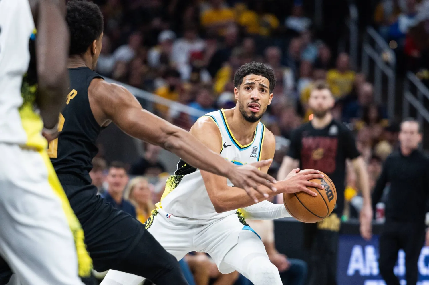 تايريس هاليبورتون لاعب إنديانا بيسرز يمسك بالكرة بينما يدافع عنها دي أندريه هانتر مهاجم كليفلاند كافالييرز (رويترز)