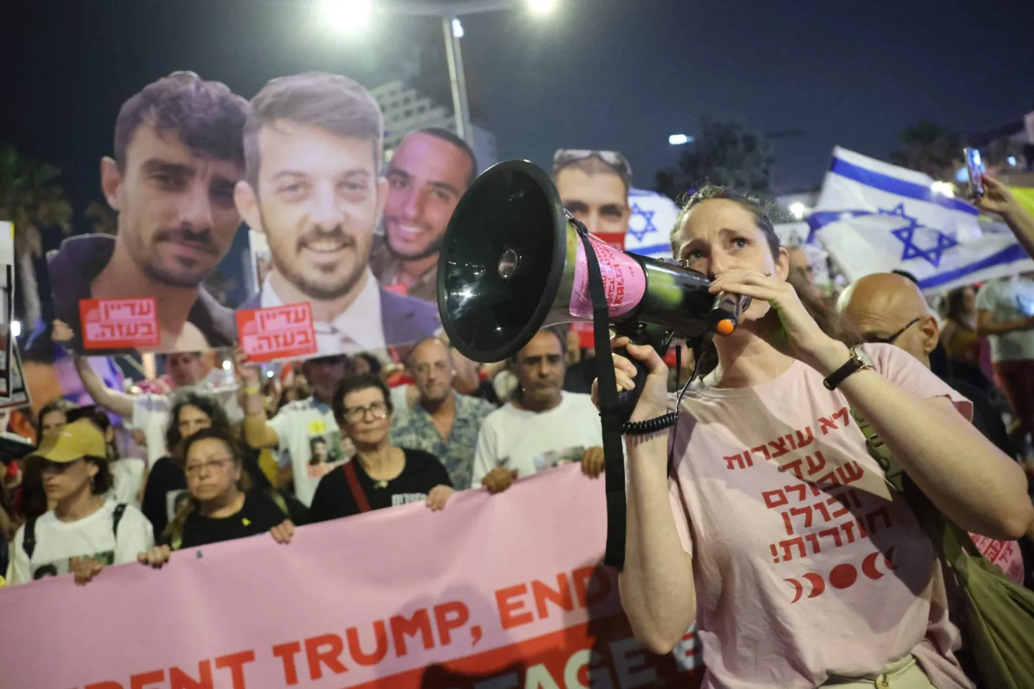 أقارب وأنصار الإسرائيليين المحتجزين في غزة يرفعون لافتات تطالب بإطلاق سراح الأسرى (أ.ف.ب)