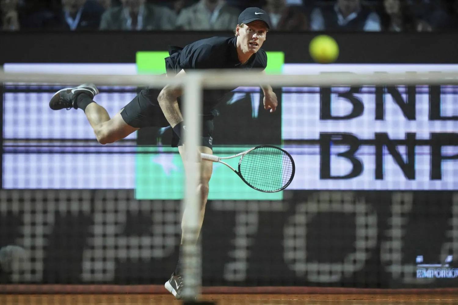 Italy's Jannik Sinner returns the ball to Tommy Paul, of the United States, during their semifinal tennis match at the Italian Open, in Rome, Friday, May 16, 2025. (AP Photo/Andrew Medichini)