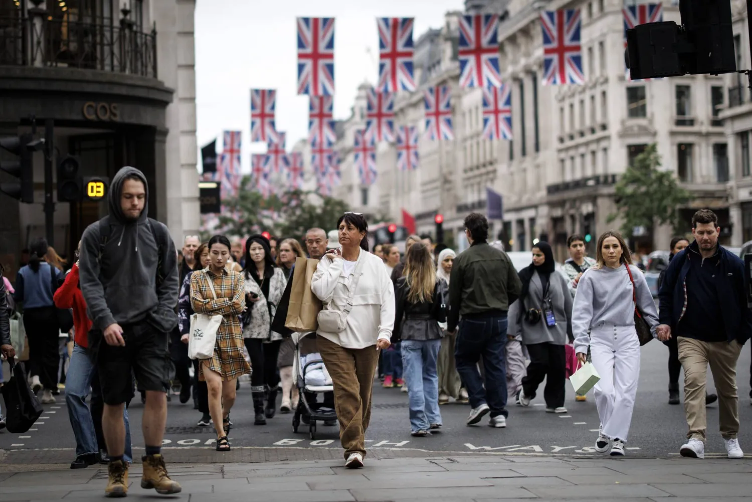 People carry shopping bags as they walk along Regent Street in London, Britain, 15 May 2025. EPA/TOLGA AKMEN