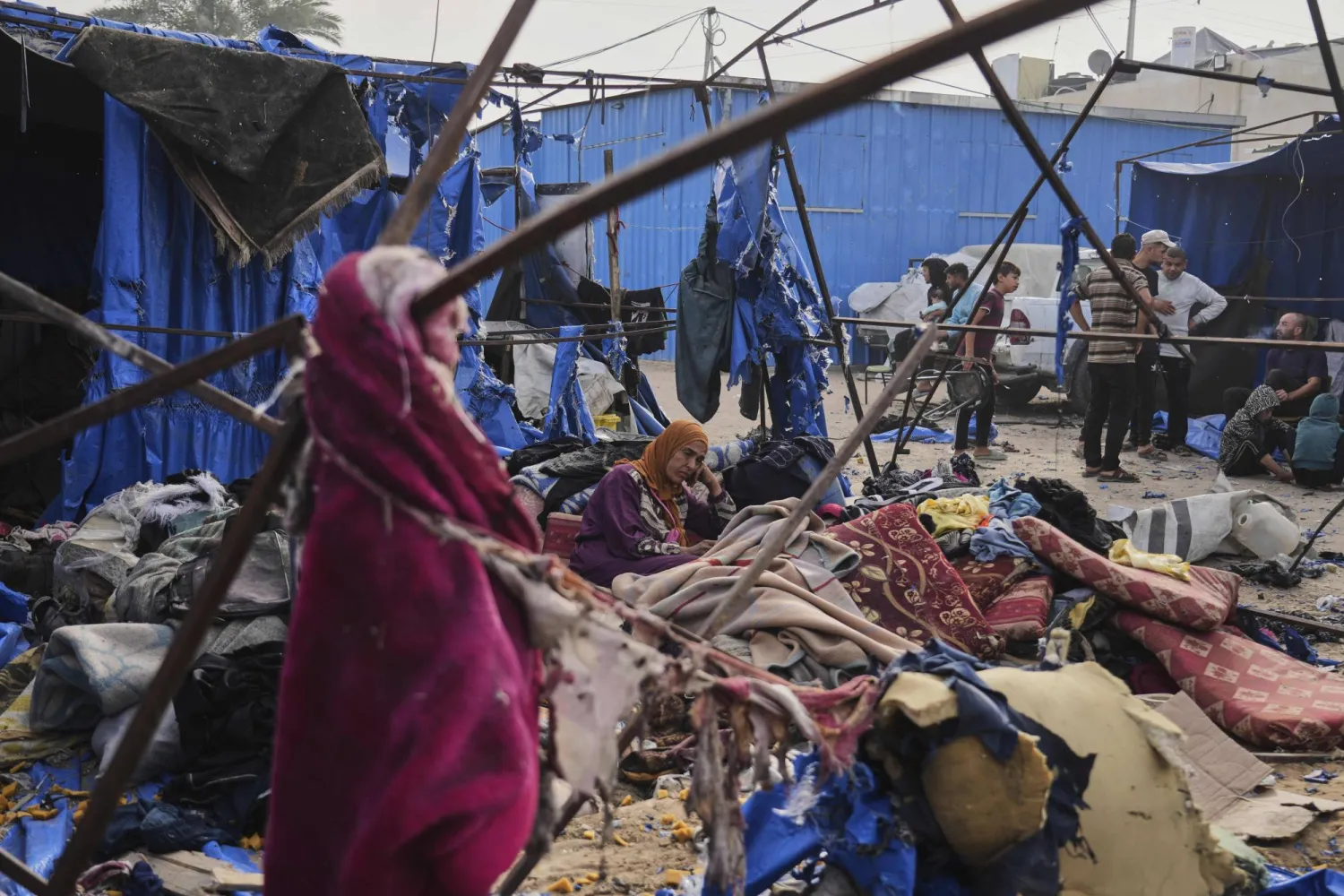 Palestinians inspect the damage caused by an Israeli airstrike that struck tents at Al-Aqsa Hospital in Deir al-Balah, central Gaza Strip, Saturday, May 17, 2025. (AP Photo/Abdel Kareem Hana)