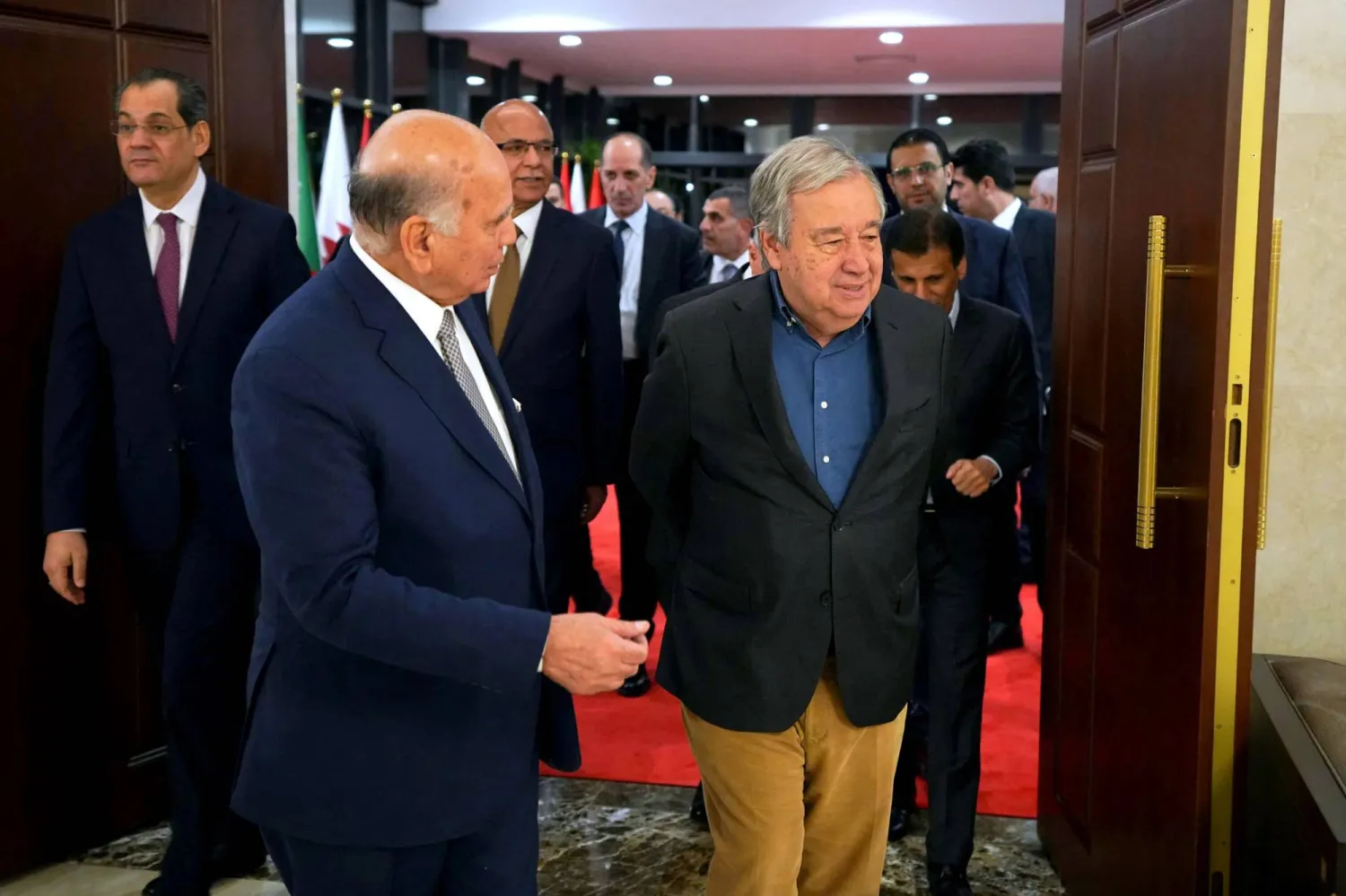 This handout picture released by the media office of Iraq's prime minister shows Iraqi Foreign Minister Fuad Hussein (L) walking with UN Secretary General Antonio Guterres before their meeting ahead of the Arab League Summit on May 15, 2025. (Photo by IRAQI PRIME MINISTER'S PRESS OFFICE / AFP) 