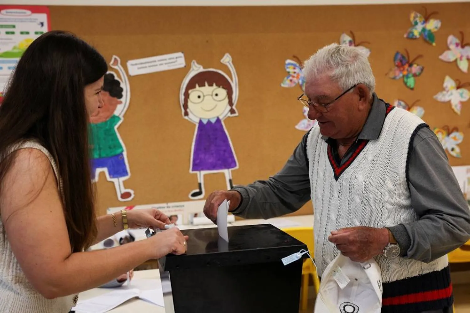 A voter casts a ballot at a polling station during the general election in Espinho, Portugal, May 18, 2025. (Reuters)