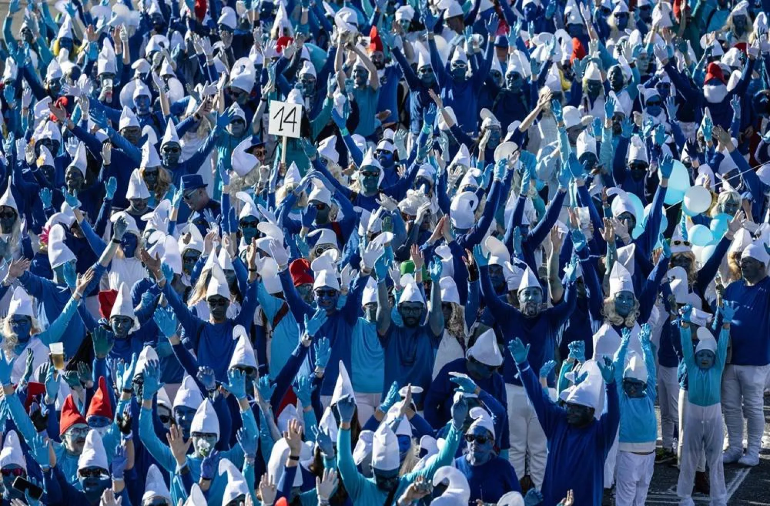 Participants wearing smurf (schtroumpf) costumes take part in an attempt to break the world record for the largest gathering of smurfs, in Landerneau, western France, on May 17, 2025. (AFP) 