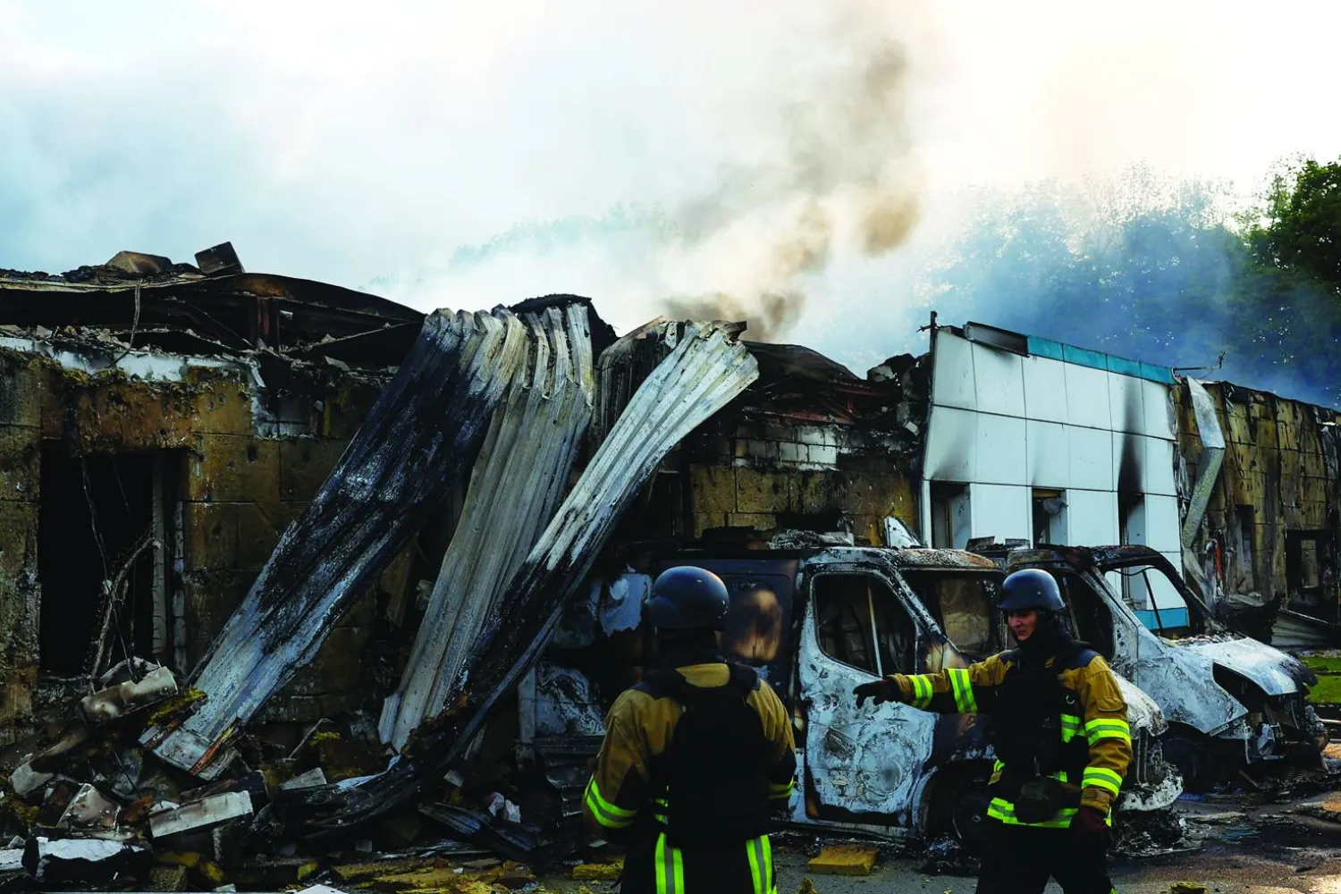 Firefighters work at the site of a private enterprise hit by a Russian drone strike, amid Russia's attack on Ukraine, outside of Kyiv, Ukraine May 18, 2025. REUTERS/Valentyn Ogirenko