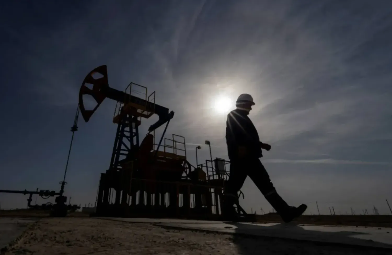FILE PHOTO: An oil and gas industry worker walks during operations of a drilling rig at Zhetybay field in the Mangystau region, Kazakhstan, November 13, 2023. REUTERS/Turar Kazangapov/File Photo