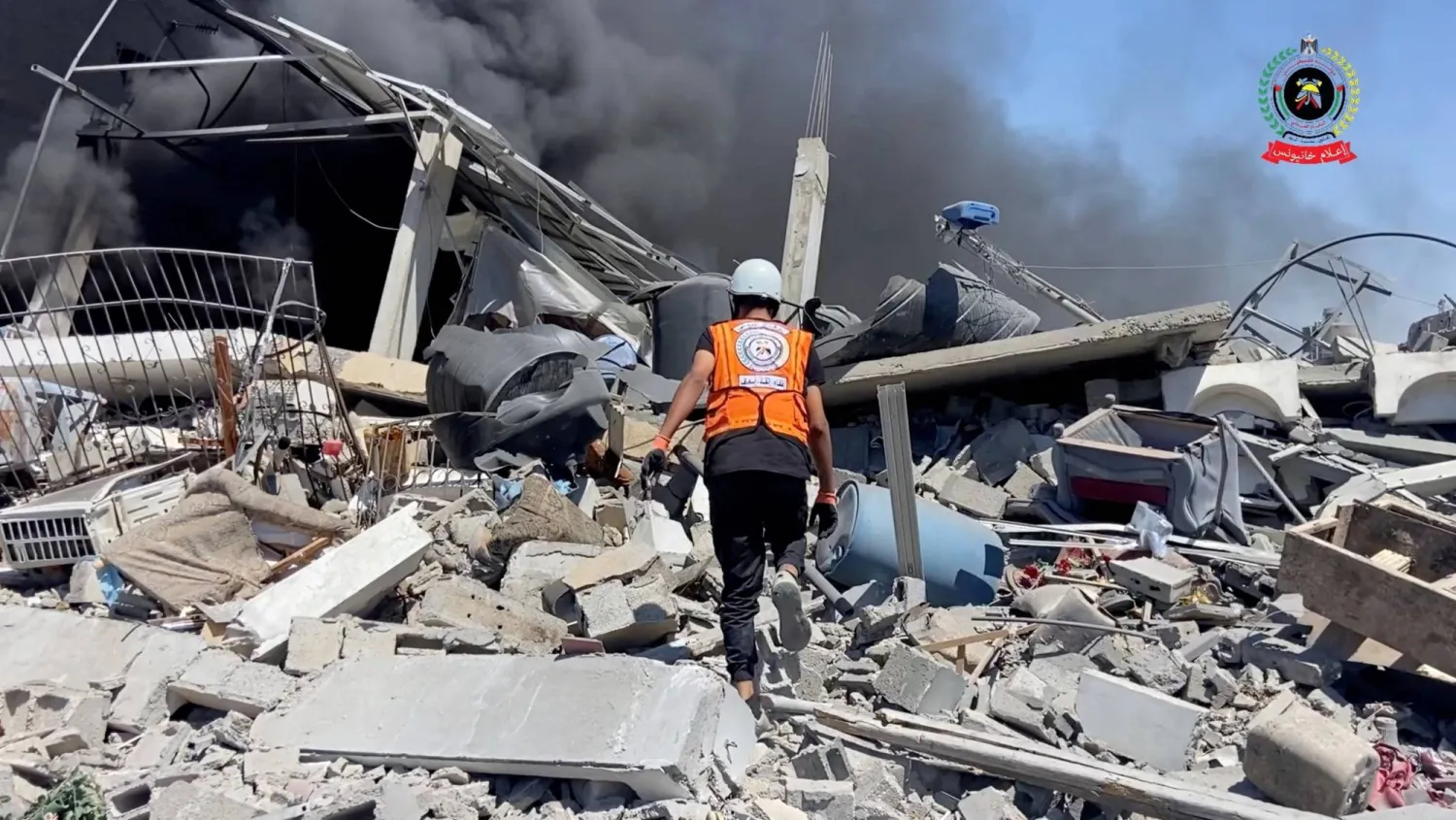 A rescuer walks over rubble to assess damage and look for survivors, in Khan Younis, Gaza, May 23, 2025, in this screengrab taken from video. Palestinian Civil Defence/Handout via REUTERS
