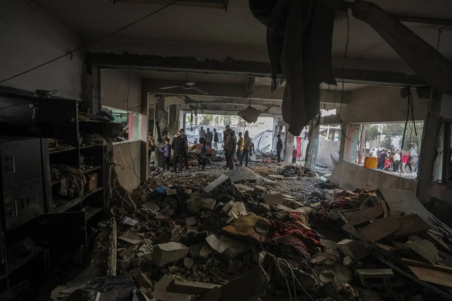 Internally displaced Palestinians inspect their destroyed shelters following Israeli airstrike in Al Jerjawi school in the Al Daraj neighborhood in Gaza City on 26 May 2025. (EPA)