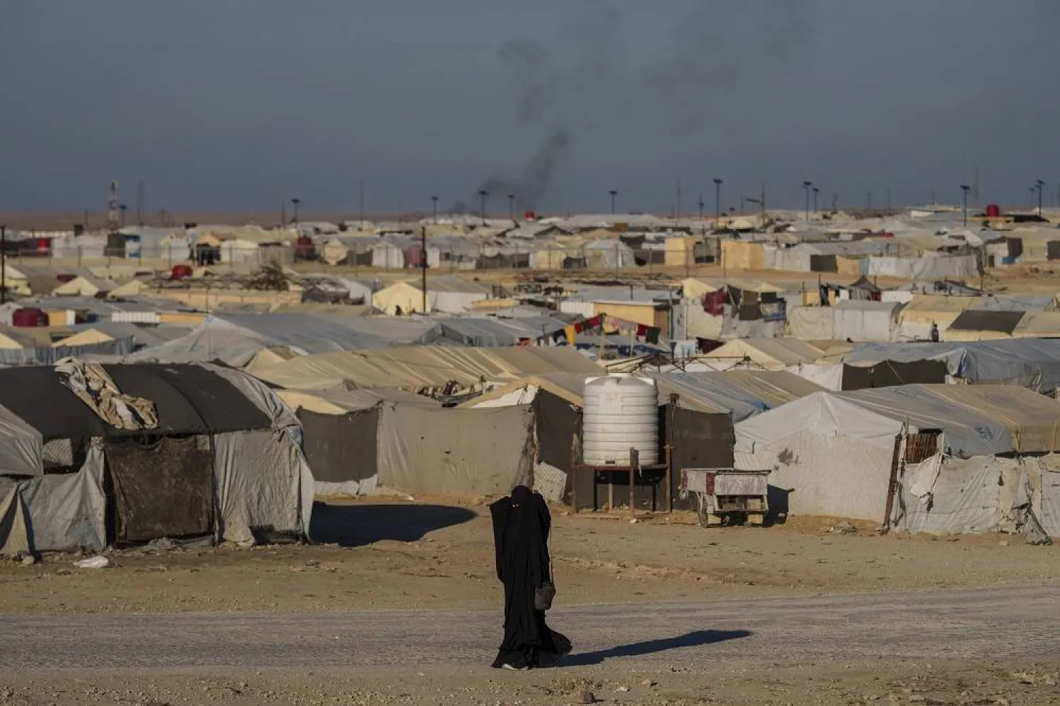 A woman walks in the al-Hol camp in northeastern Syria's Hasakeh province, where tens of thousands of mostly women and children linked to the ISIS group have been living for years, Thursday, Jan. 30, 2025. (AFP) 