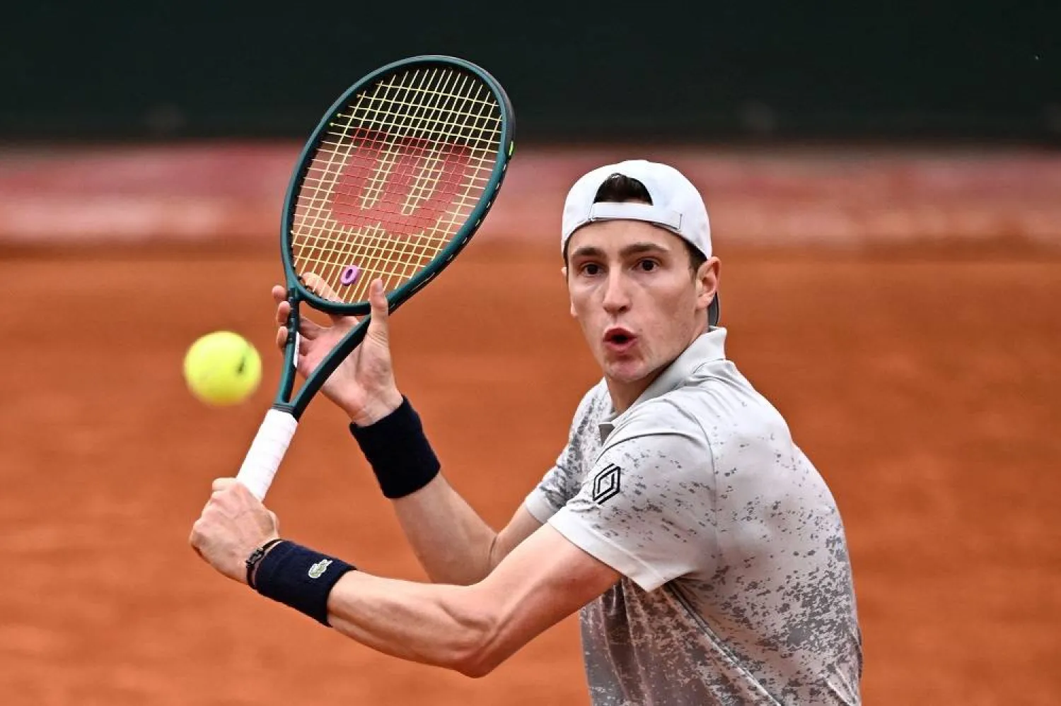 France's Ugo Humbert plays a backhand return to Australia's Christopher O'Connell during their singles match on day 2 of the French Open tennis tournament at the Roland-Garros Complex in Paris on May 26, 2025. (AFP) 