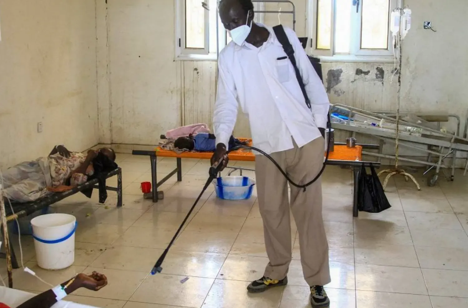 A man disinfects a rural isolation center where patients are being treated for cholera in Wad Al-Hilu in Kassala state in eastern Sudan, on August 17, 2024. (AFP)
