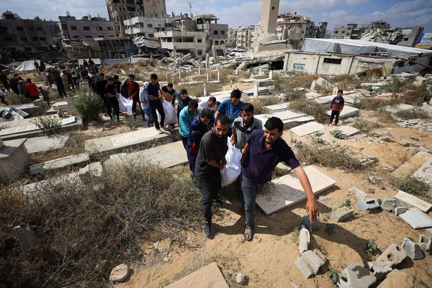 Mourners carry the bodies of members of the Al-Arabeed family killed in Israeli strikes, at a cemetery, in Gaza City, May 28, 2025. (Reuters)