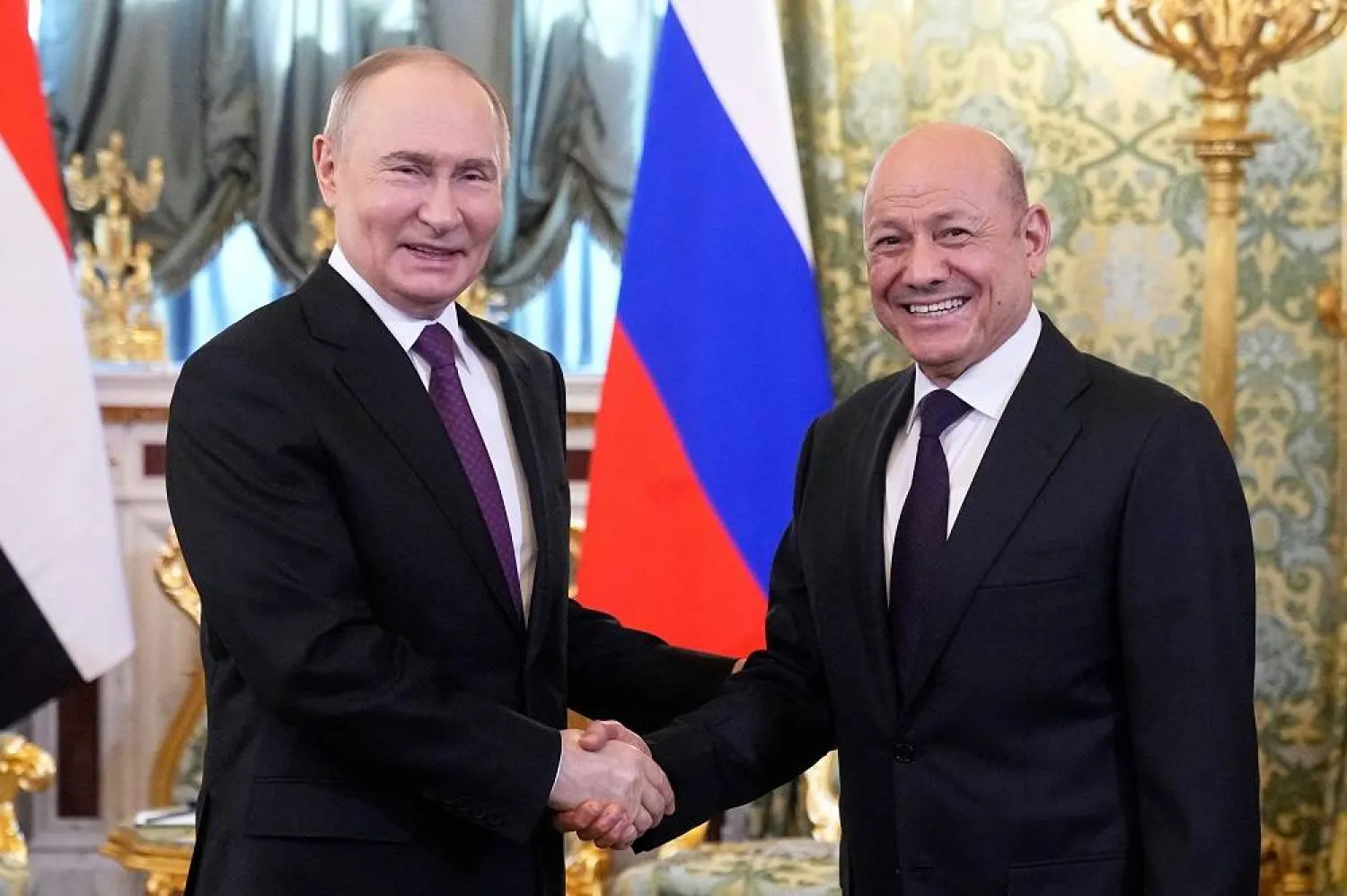 Russian President Vladimir Putin (L) shakes hands with Yemen's Presidential Leadership Council Chairman Dr. Rashad Al-Alimi (R) during their meeting at the Grand Kremlin Palace in Moscow, Russia, 28 May 2025. (EPA) 