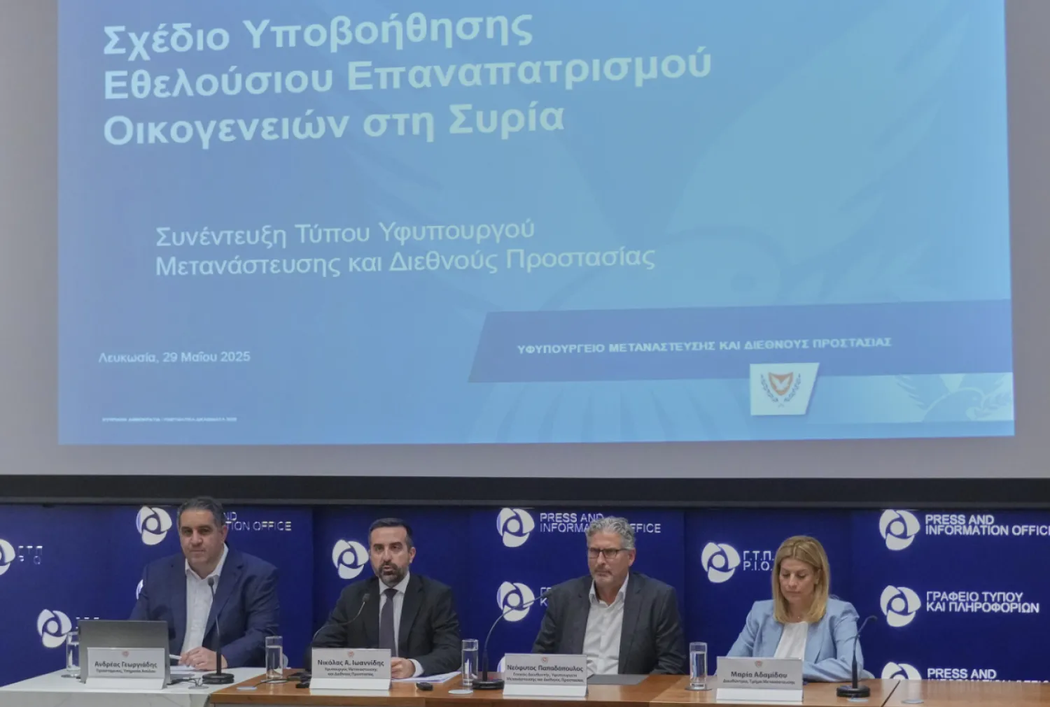 Cyprus' deputy minister for migration Nicholas loannides, second left, explains how a new voluntary repatriation program for Syrian families living in Cyprus will work during a press conference, at the Press and Informations office in the capital Nicosia, Cyprus, Thursday, May 29, 2025. (AP Photo/Petros Karadjias)