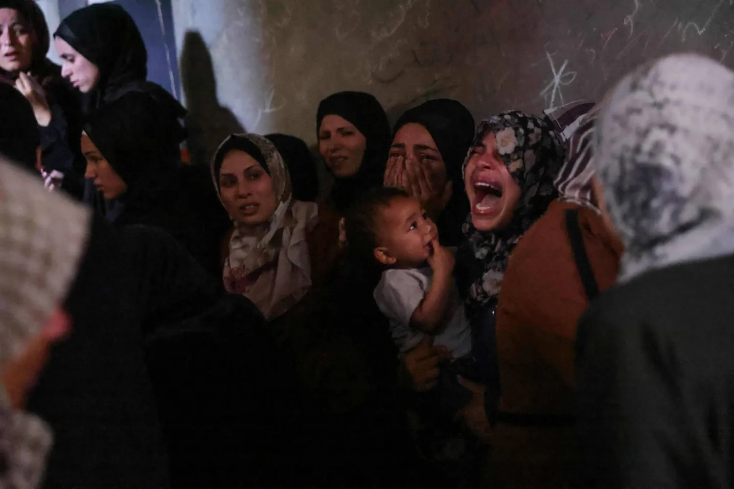 Palestinians mourn members of the Azzam family who were killed in Israeli strikes on their home in central Jabalia in the northern Gaza Strip on May 29, 2025.  (Photo by Bashar TALEB / AFP)