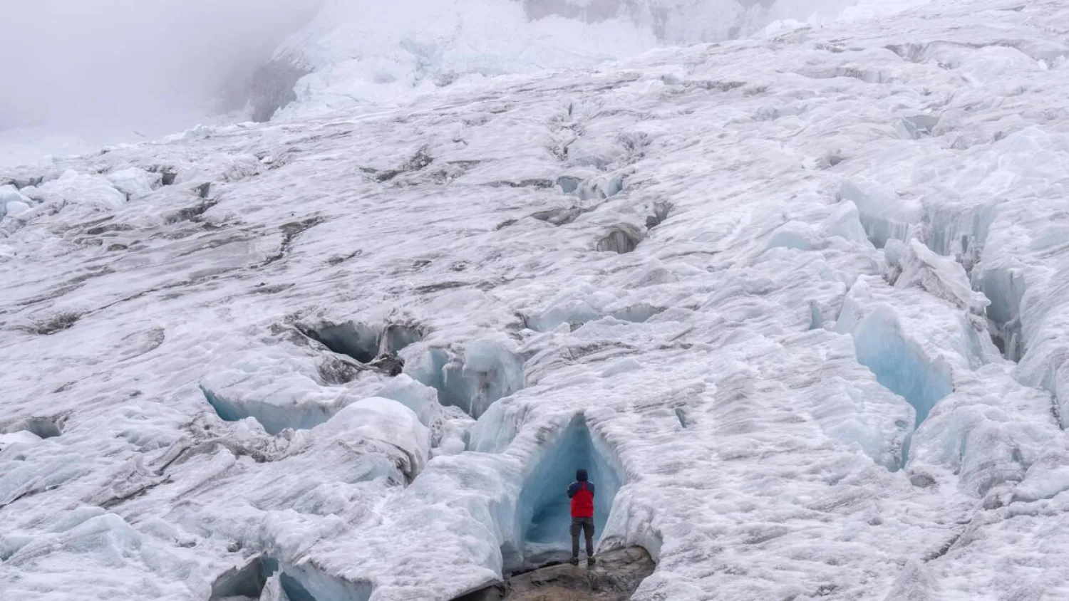 A tourist explores the Ritacuba Blanco glacier at the Natural National Park Nevado El Cocuy in Boyaca Department, Colombia, on April 19, 2024. Luis ACOSTA / AFP/File
