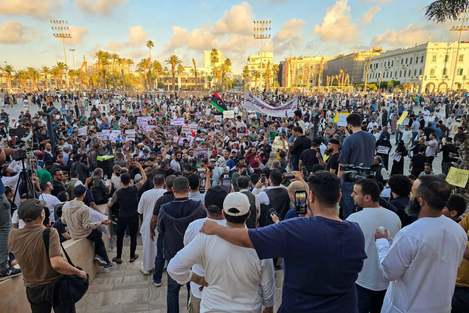 
متظاهرون يتجمعون في احتجاج مناهض للحكومة مطالبين حكومة الوحدة الوطنية برئاسة عبد الحميد الدبيبة بالاستقالة في ساحة الشهداء في العاصمة الليبية طرابلس (أ.ف.ب)
