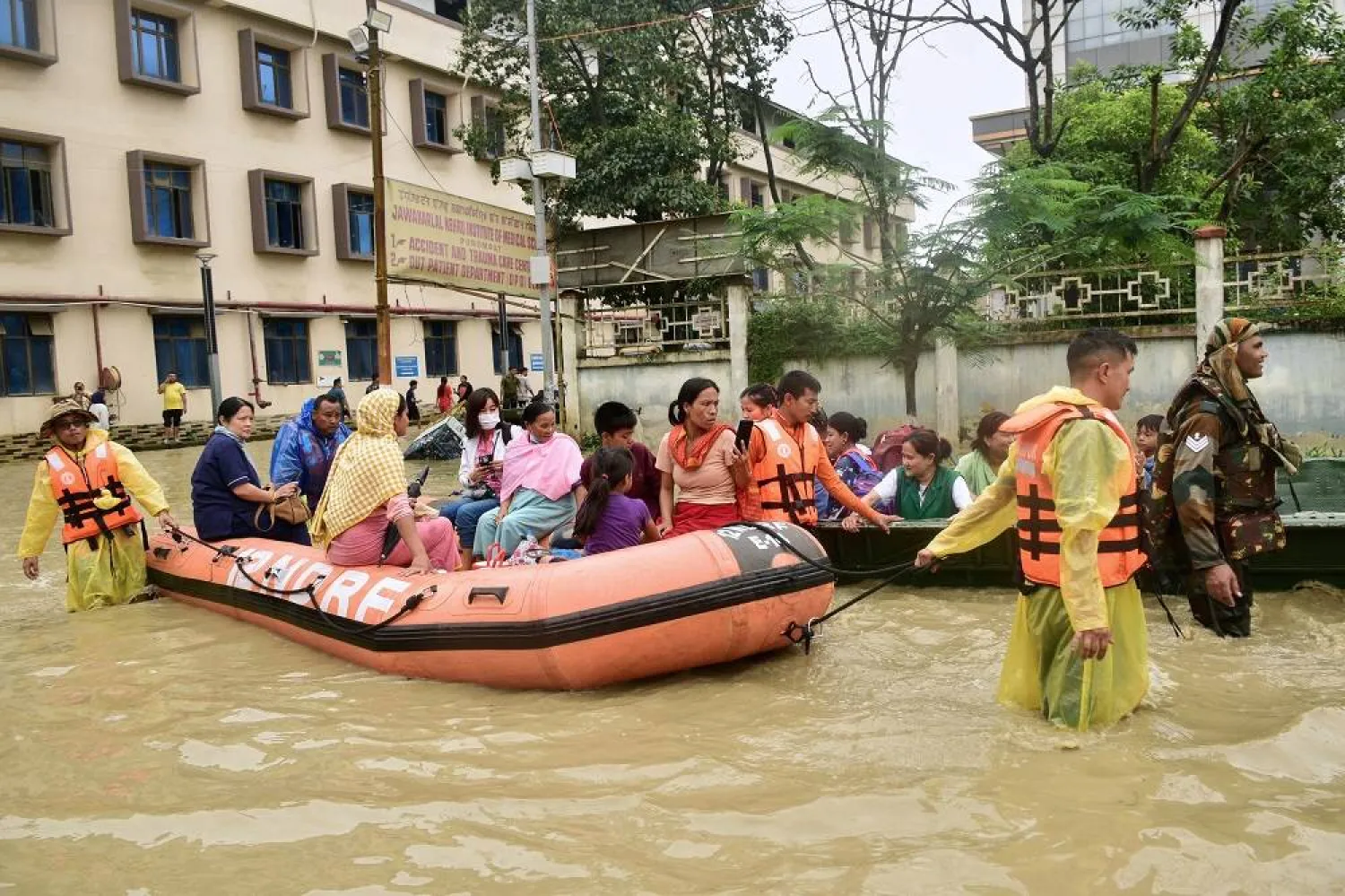 Army soldiers and rescuers evacuate patients and medical staff from a flooded hospital following landslides and flash flooding in Imphal in India's northeast state of Manipur, Sunday, June 1, 2025. (AP)