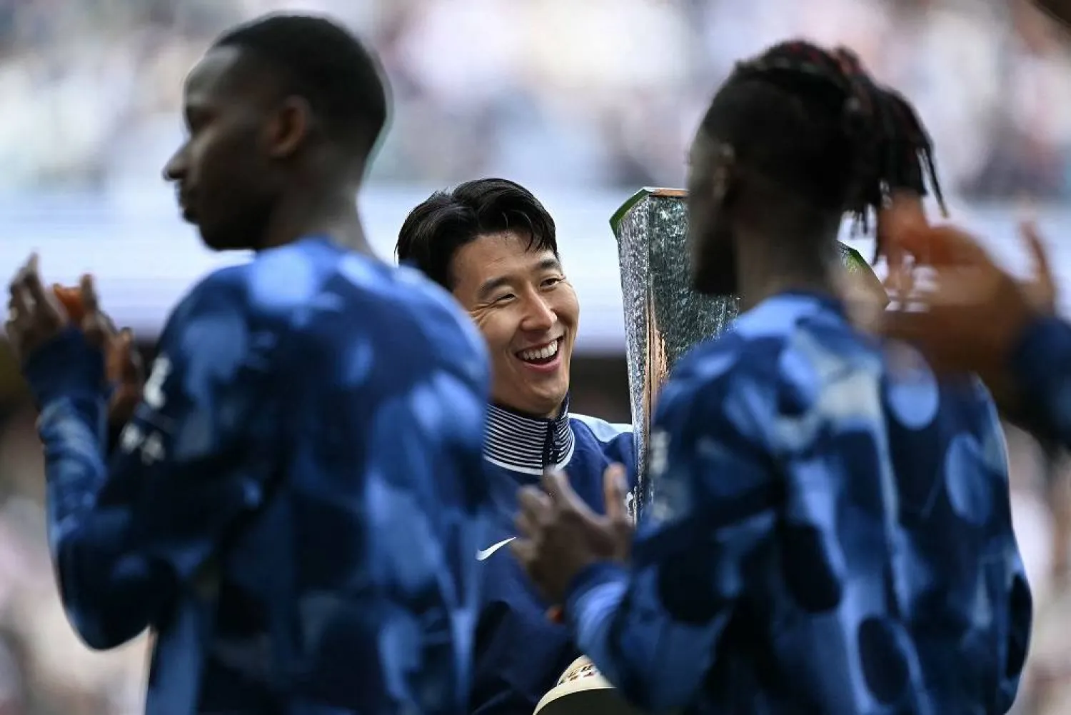 Tottenham Hotspur's South Korean forward #07 Son Heung-min carries the Europa League trophy, following their mid-week win in the Europa League Final on May 21, as he and the team display it for fans following the English Premier League football match between Tottenham Hotspur and Brighton and Hove Albion at the Tottenham Hotspur Stadium in London, on May 25, 2025. (AFP) 