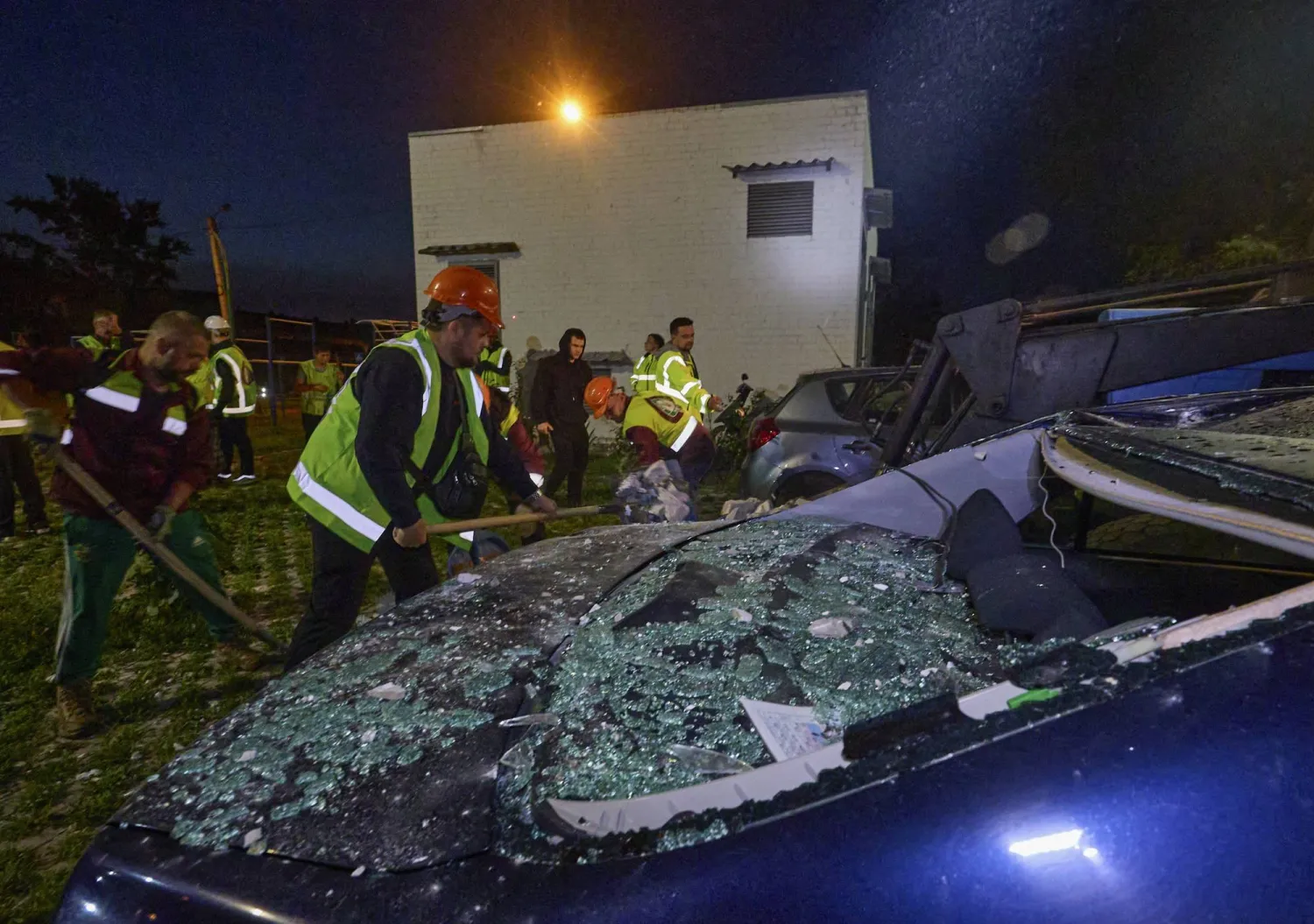 عمال يزيلون حطاماً سببه قصف بمسيّرة روسية لمدينة خاركيف الأوكرانية (إ.ب.أ)