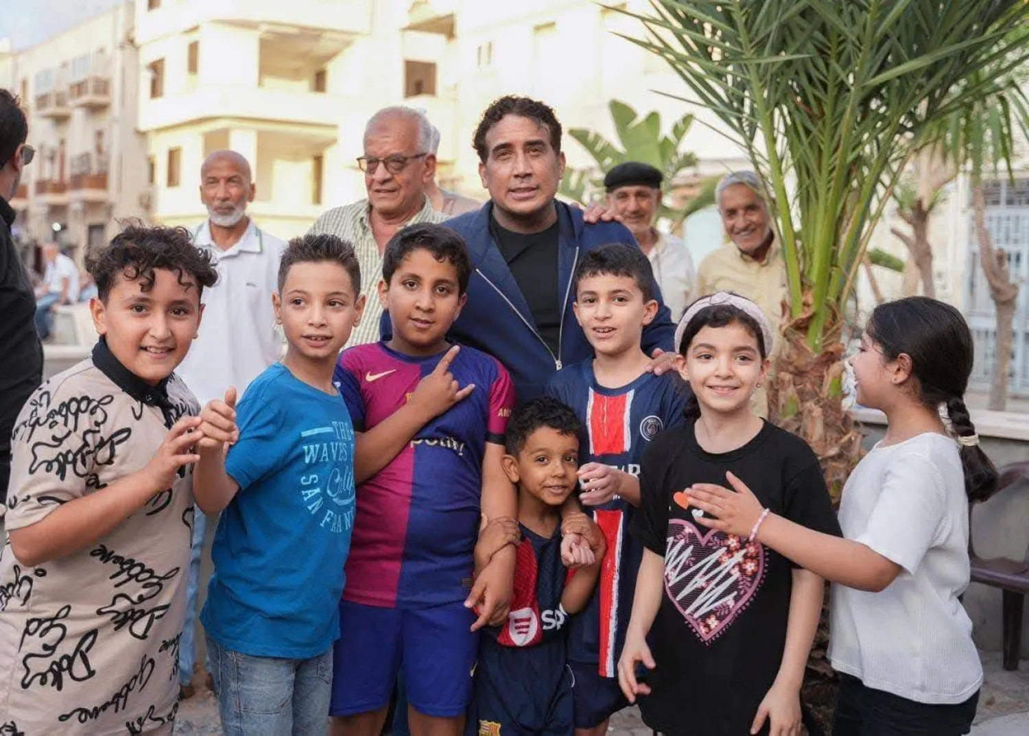 المنفي يتوسط أطفالاً ليبيين خلال جولته في شوارع طرابلس (مكتب المنفي)