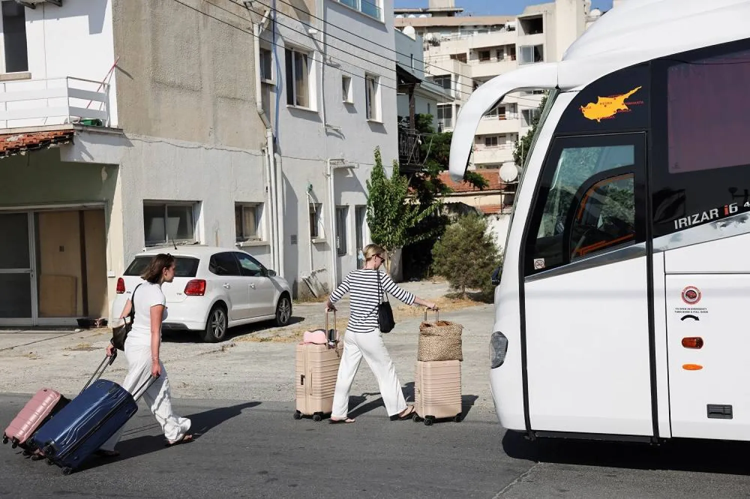 Passengers from the Crown Iris a cruise ship board a bus, at the port of Larnaca, Cyprus, June 18, 2025. (Reuters)