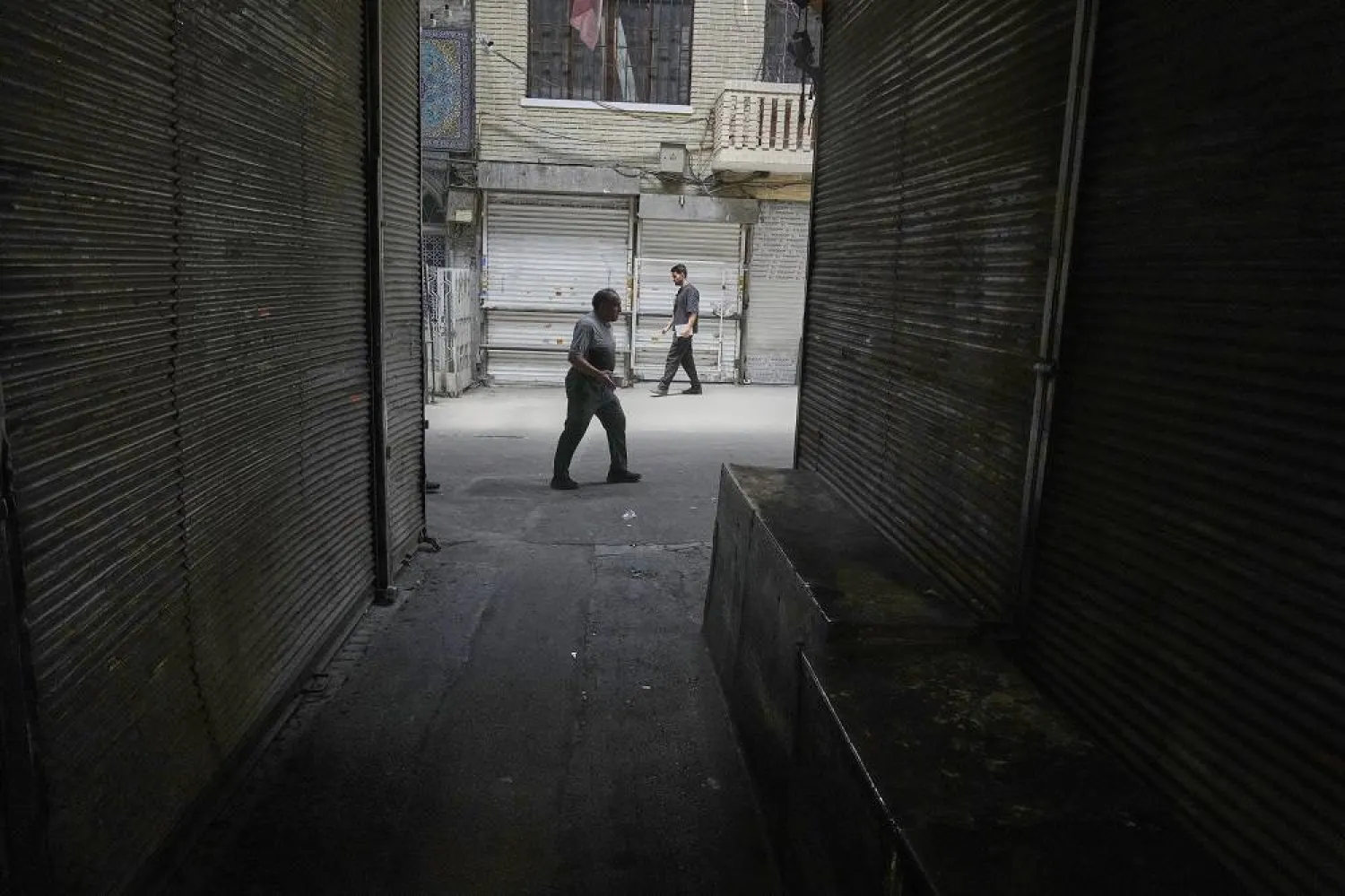 Few pedestrians walk along the historic Grand Bazaar as most shops remain shuttered, in Tehran, Iran, Monday, June 16, 2025. (AP) 