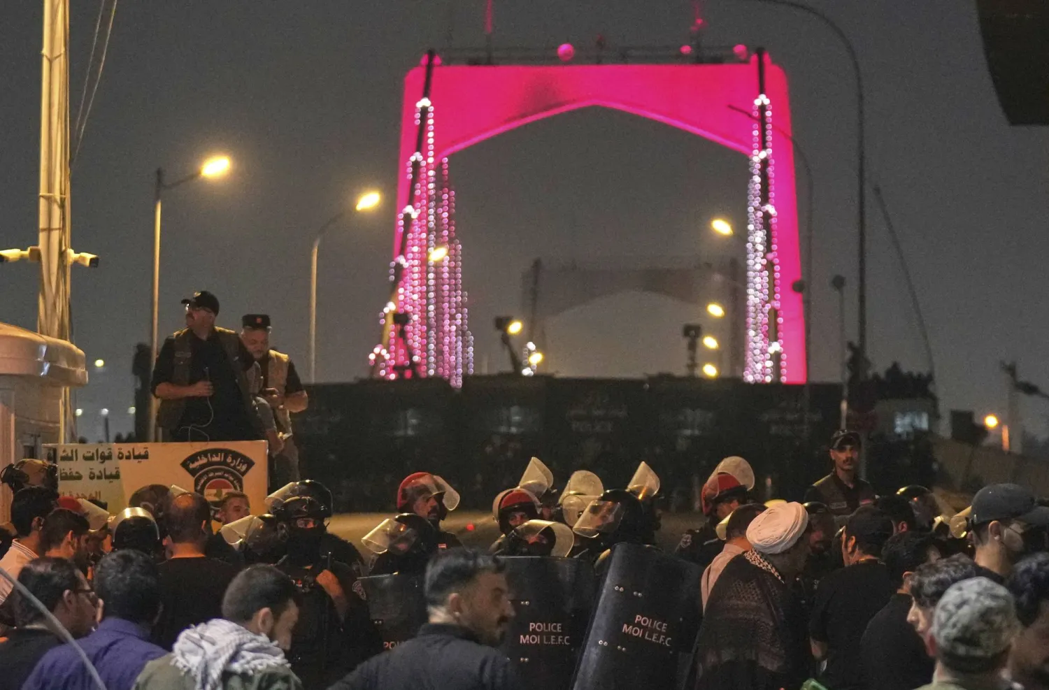 قوات أمن عراقية تقطع الطريق إلى الجسر المؤدي إلى السفارة الأميركية في المنطقة الخضراء ببغداد (أ.ب)