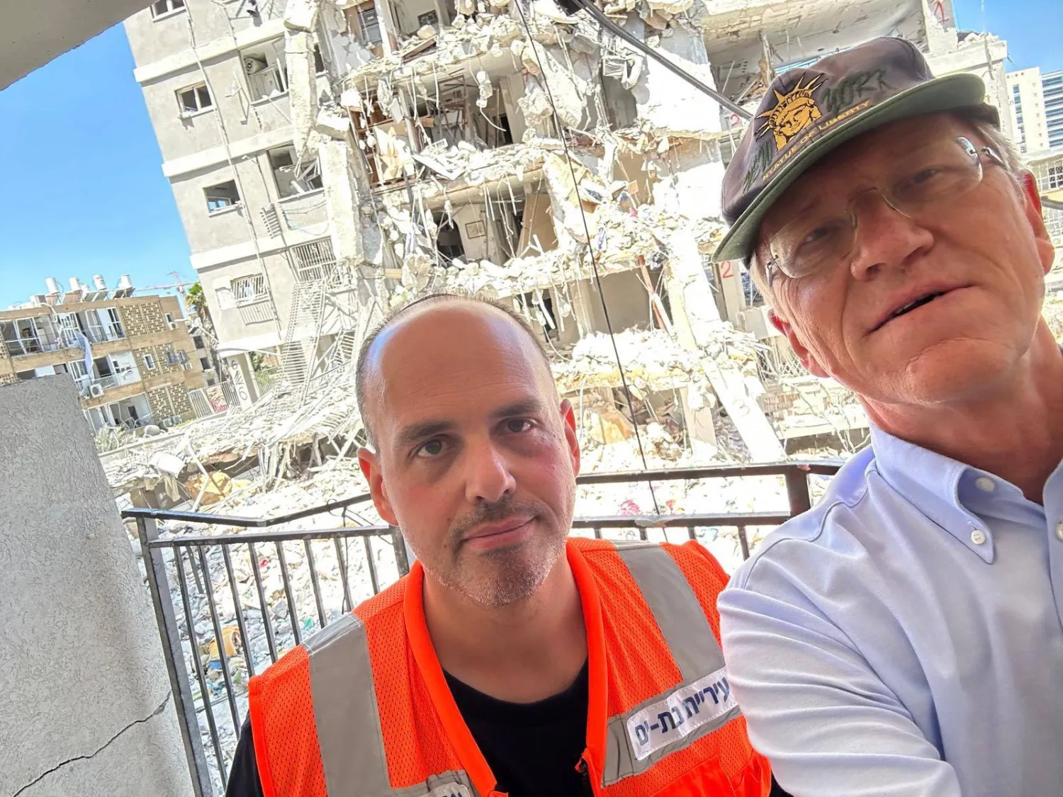 سفير النرويج لدى إسرائيل بير إيجل سيلفاج (يمين) خلال زيارته أحد المباني المتضررة من القصف الإيراني في بات يام (حساب السفارة عبر منصة إكس) 