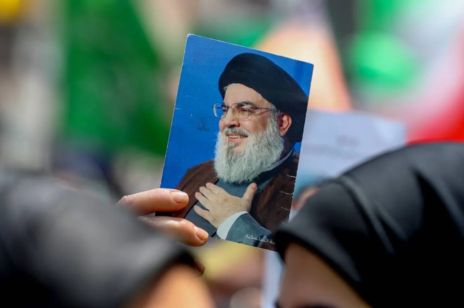 A supporter of Hezbollah carries a picture of Hezbollah's late leader Hassan Nasrallah during a protest against the Israeli attack on Iran, organized by Hezbollah following Friday prayer in the southern suburbs of Beirut, Lebanon, 20 June 2025. (EPA)