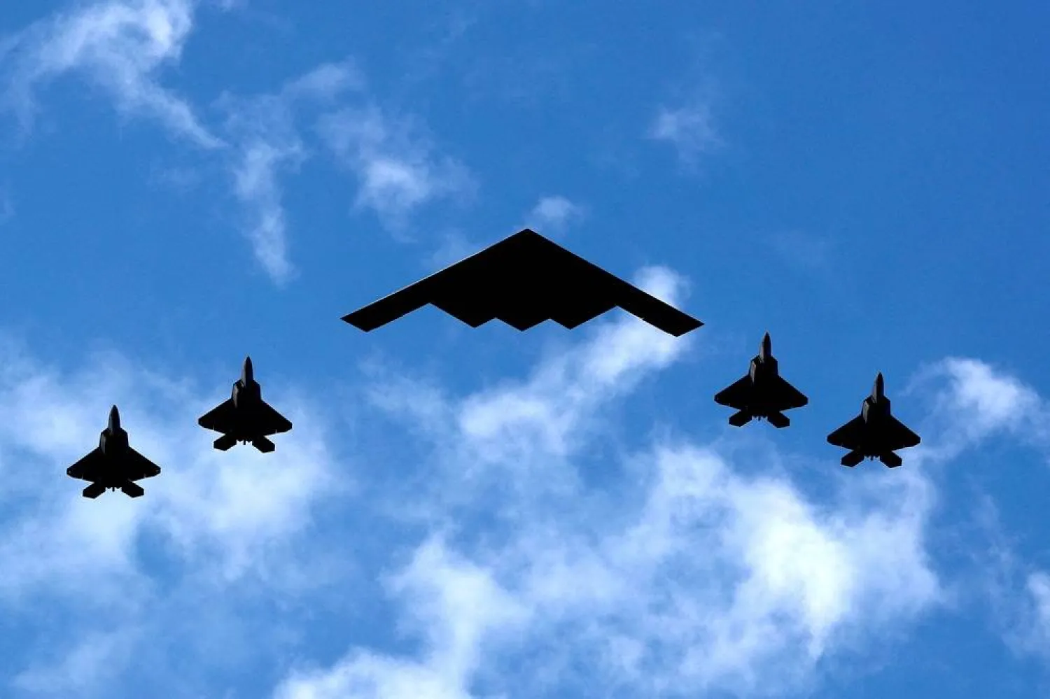 A US Air Force B-2 Spirit Stealth Bomber (C) is flanked by four US Marine Corps F-35 fighters during a flyover of military aircraft down the Hudson River and New York Harbor past York City, and New Jersey, US, July 4, 2020. (Reuters) 