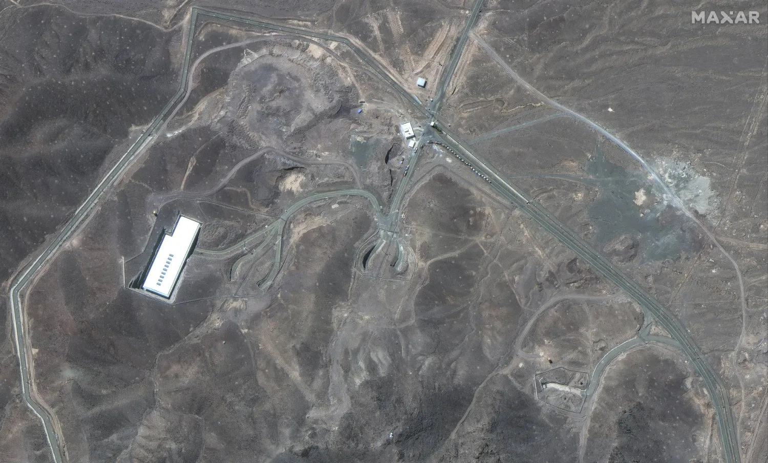 This satellite image provided by Maxar Technologies shows vehicles at Fordo enrichment facility in Iran on Thursday, June 19, 2025. (Maxar Technologies via AP)