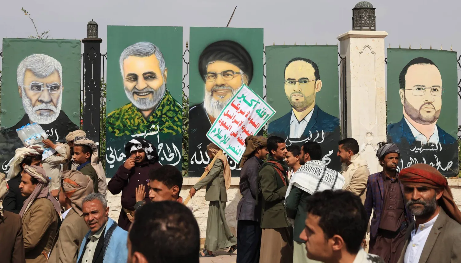 Houthi supporters gather near paintings depicting late military and political figures of Iran-backed groups of Yemen, Lebanon, Palestine and Iraq on display on a fence during a protest against the Israeli airstrikes on Iran, in Sanaa, Yemen, 20 June 2025. EPA/YAHYA ARHAB