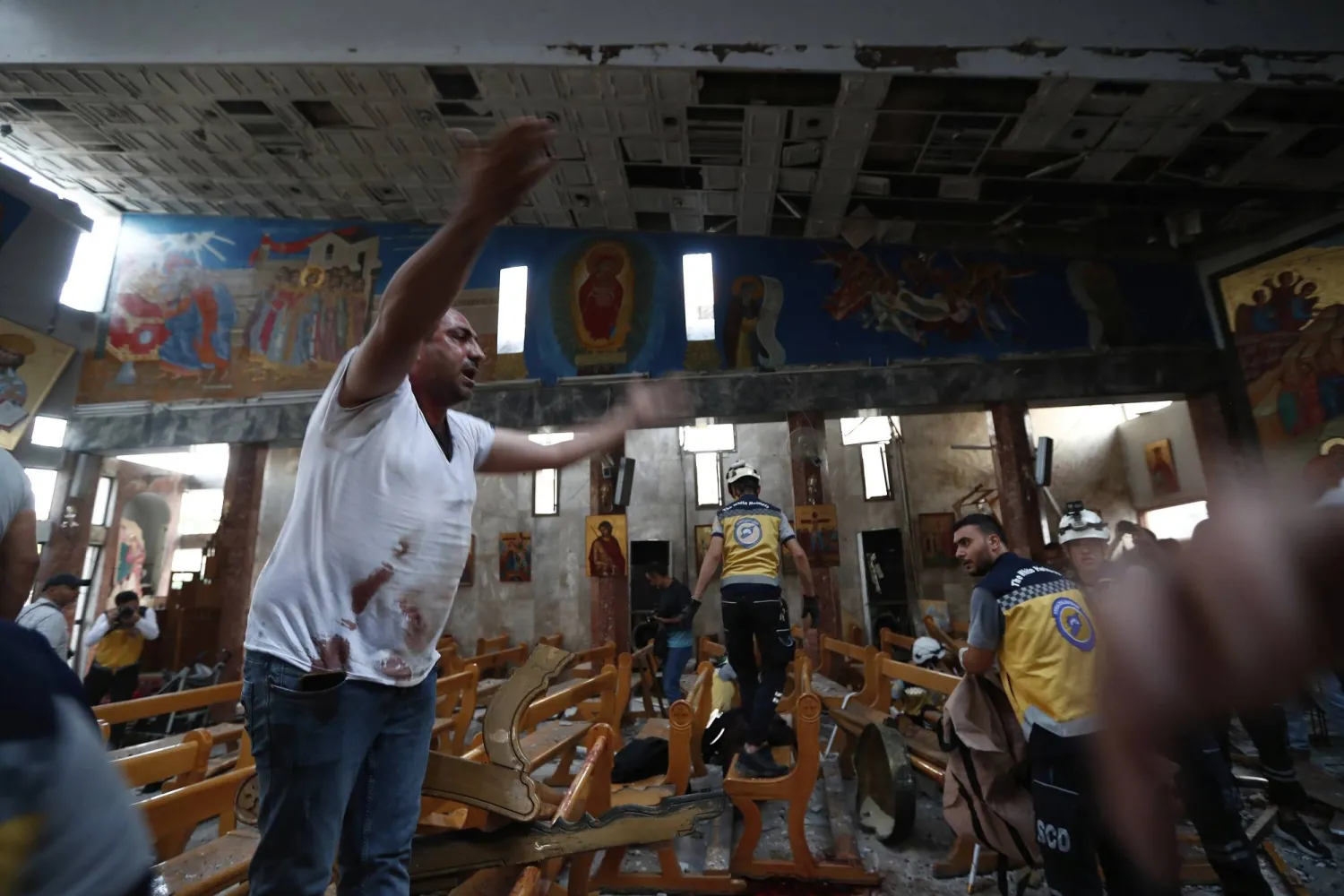 A Syrian man reacts inside Mar Elias church where a suicide bomber detonated himself in Dweila in the outskirts of Damascus, Syria, Sunday June 22, 2025. (AP Photo/Omar Sanadiki)